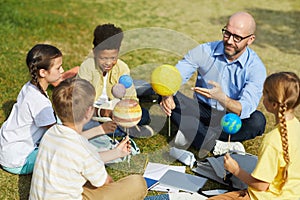 Group of Kids Enjoying Astronomy Lesson Outdoors