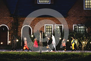 Group of kids with Halloween costumes walking to trick or treating photo