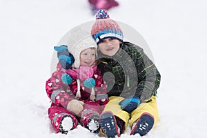 Group of kids having fun and play together in fresh snow