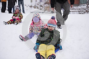 Group of kids having fun and play together in fresh snow