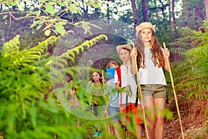 Group of kids on a hiking trail in the forest