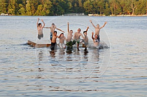 Group of kids jumping into Lake