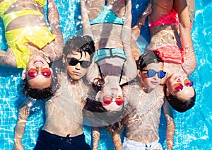 Group of kids ln in swimming pool from above