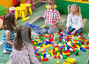 Group of kids playing with colorful constructor photo