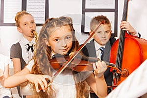 Group of kids playing musical instruments together