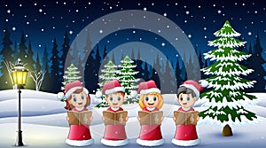 Group of kids in red santa costume singing christmas carols on the winter background