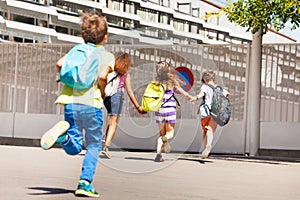 Group of kids run to school one after another