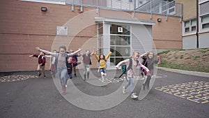 Group of kids running happy to finish school day