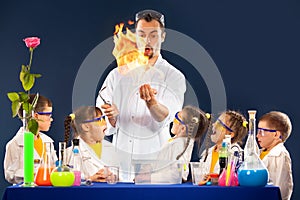 Group kids and scientist doing experiments with fire in laboratory