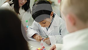 Group of kids scientist students holding molecules at laboratory classroom