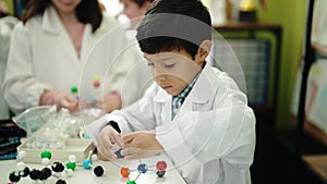 Group of kids scientist students holding molecules at laboratory classroom