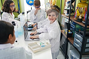 Group of kids scientists students using laptop at laboratory classroom