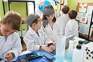 Group of kids scientists students using laptop at laboratory classroom
