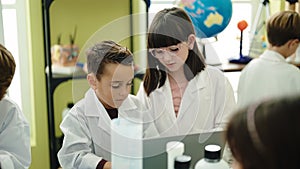 Group of kids scientists students using laptop at laboratory classroom