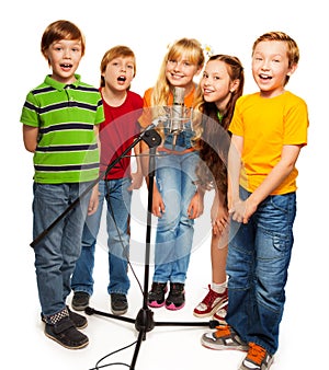 Group of kids singing to microphone photo
