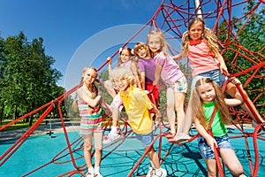 Group of kids sitting together on red ropes