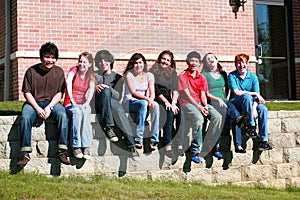 Group of kids sitting on wall