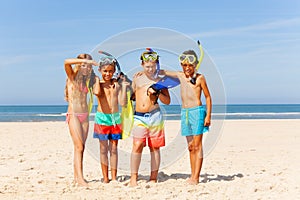 Group of kids with snorkeling equipment on beach
