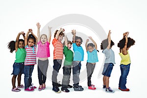 Group of kids standing in a line with raised arms
