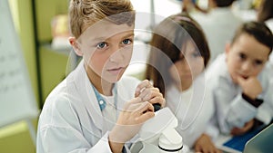 Group of kids students using microscope at laboratory classroom