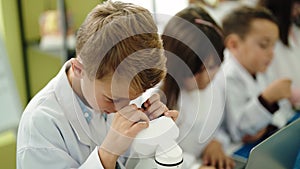 Group of kids students using microscope at laboratory classroom