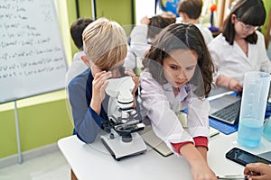 Group of kids students using microscope at laboratory classroom
