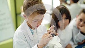 Group of kids students using microscope and laptop at laboratory classroom