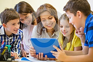 Group of kids with teacher and tablet pc at school