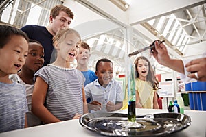 Group of kids and teachers carrying out a science experiment