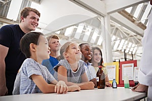 Group of kids with teachers having fun at a science centre