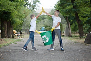 Group of kids volunteer help garbage collection charity environment, selective soft focus. Team work.