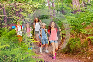 Group of kids walking and hiking in the forest