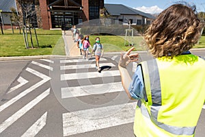 Group of kids wearing face masks crossing the road