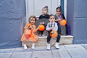 Group of kids wearing halloween costume holding pumpkin basket at street