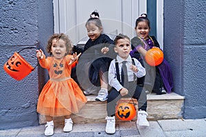 Group of kids wearing halloween costume holding pumpkin basket at street