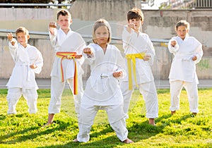 Group of kids in white kimono training