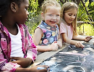 Group of kindergarten kids friends drawing art class outdoors