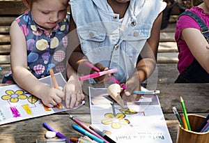 Group of kindergarten kids friends drawing art class outdoors