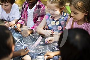 Group of kindergarten kids friends drawing art class outdoors