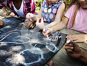 Group of kindergarten kids friends drawing art class outdoors