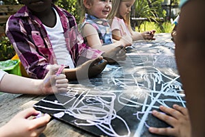 Group of kindergarten kids friends drawing art class outdoors