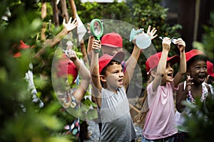 Group of kindergarten kids learning gardening outdoors photo