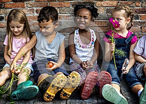 Group of kindergarten kids little farmers learning gardening