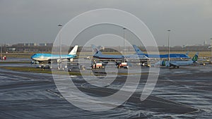 Group of KLM planes in the Amsterdam AIrport Schiphol in the Netherlands on a gloomy day