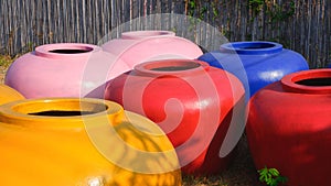 Group of large colorful water jars with a capacity of 2000 liters of water for sale in rural village at Thailand