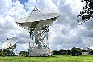 Group of large satellite dishes with cloudy sky in Thailand