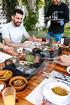 Group of latin friends eating mexican food in the restaurant terrace in Mexico Latin America