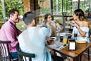 Group of latin friends eating mexican food in the restaurant terrace in Mexico Latin America