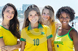 Group of laughing brazilian soccer fans outdoor in the city