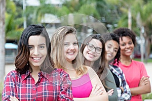 Group of laughing international girls standing in line